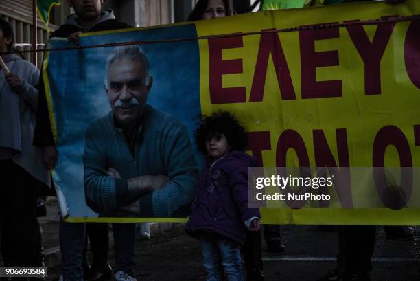 Kurdish in Athens, hold a portrait of Kurdistan Worker's Party jailed leader Abdullah Ocalan and flags, during a protest in support of Afrin, in...