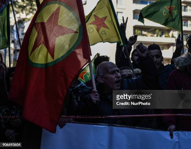 Kurdish in Athens, hold a portrait of Kurdistan Worker's Party jailed leader Abdullah Ocalan and flags, during a protest in support of Afrin, in...