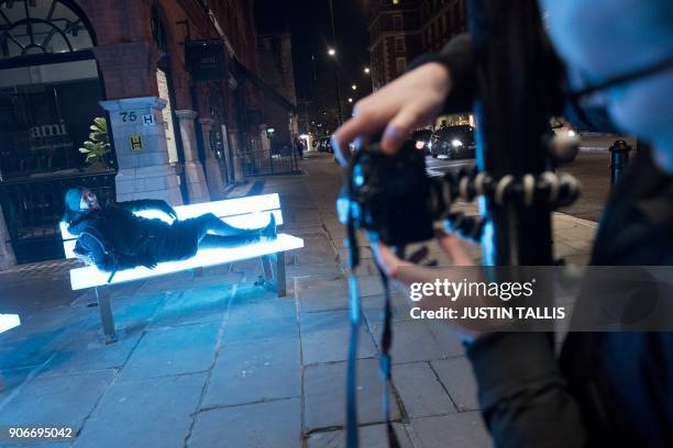 Woman poses for a photograph on Lightbench by Bernd Spiecker for LBO LichtBankObjekte, on show as part of the Lumiere London light festival in London...