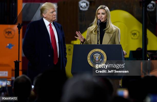 President Donald Trump listens to his daughter, Ivanka Trump, speak to supporters at a rally at H&K Equipment, a rental and sales company for...