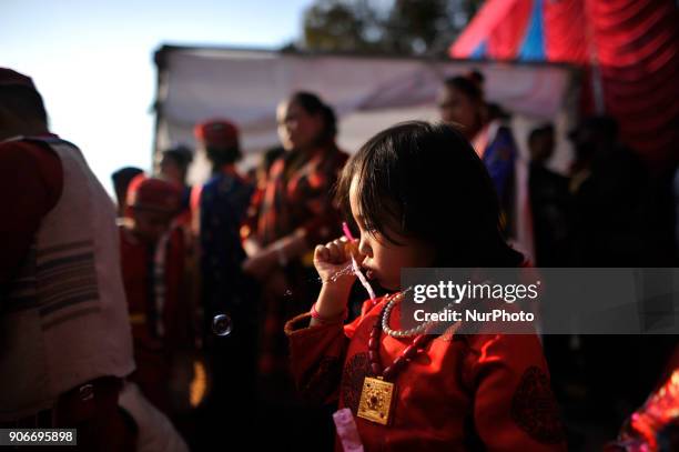 Little girl making soap bubbles during celebration of Sonam Losar festival or Lunar New Year, which occurs around the same time of year as does...