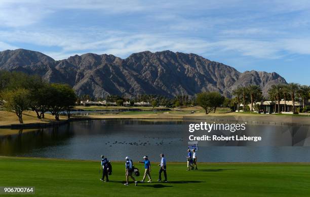The group of Derek Fathauer and Steve Wheatcroft walk along the ninth hole during the first round of the CareerBuilder Challenge at the Jack Nicklaus...