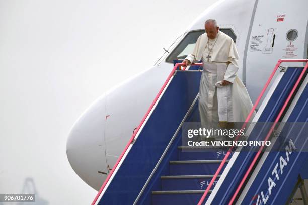 Pope Francis disembarks from his plane on arrival at an air force base in Lima on January 18, 2018. - Pope Francis headed Thursday to Peru on the...