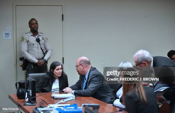 Louise Turpin speaks with attorney Jeff Moore as David Turpin speaks with attorneys David Macher and Allison Lowe during their court arraignment in...