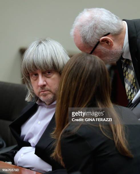David Turpin listens to attorneys David Macher and Allison Lowe during their court arraignment in Riverside, California on January 18, 2018. The...