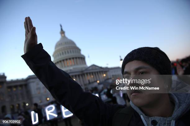 Protesters advocating for the DREAM Act hold a candlelight vigil outside the U.S. Capitol on January 18, 2018 in Washington, DC. Congress continues...
