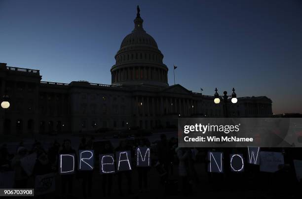 Protesters advocating for the DREAM Act hold a candlelight vigil outside the U.S. Capitol on January 18, 2018 in Washington, DC. Congress continues...