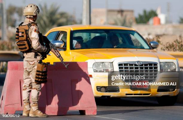 Iraqi soldiers control one of several checkpoints they set up along the main 50 kilometre road between the area of Karmat Ali on the northern...