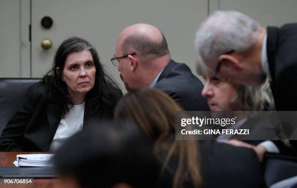 David Turpin confers with attorneys Allison Lowe and David Macher as Louise Turpin confers with attorney Jeff Moore during their court arraignment in...