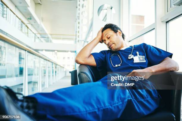 stanco medico professionista che dorme nel salone dell'ospedale - stanchezza foto e immagini stock