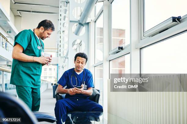 medical professionals using mobile phone in hospital - doctor smartphone stock pictures, royalty-free photos & images