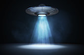 Light beam from flying UFO (alien spaceship). 3D rendered illustration.