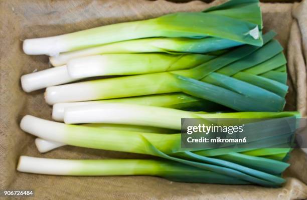 fresh leeks in shop for vegetarian meal. - leek stock pictures, royalty-free photos & images