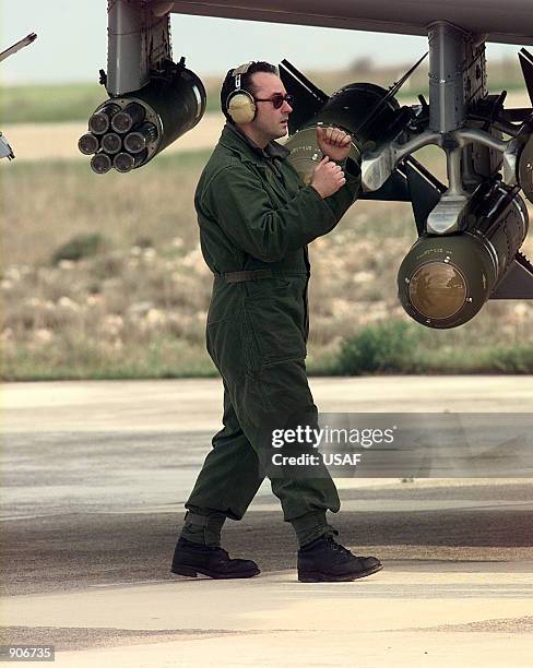 An A-10 Thunderbolt II crew chief from the 81st Expeditionary Fighter Squadron gives the signal to shut down engines after aircraft arrive from...