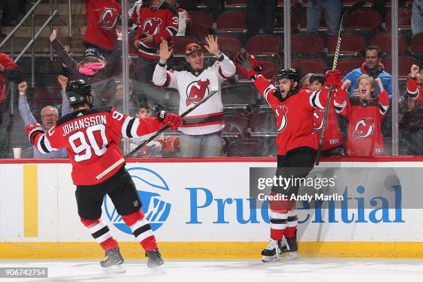 Drew Stafford of the New Jersey Devils celebrates his first period goal with Marcus Johansson during the game against the Washington Capitals at...