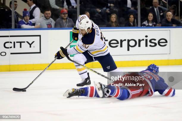 Ryan O'Reilly of the Buffalo Sabres skates against Kevin Shattenkirk of the New York Rangers in the first period during their game at Madison Square...