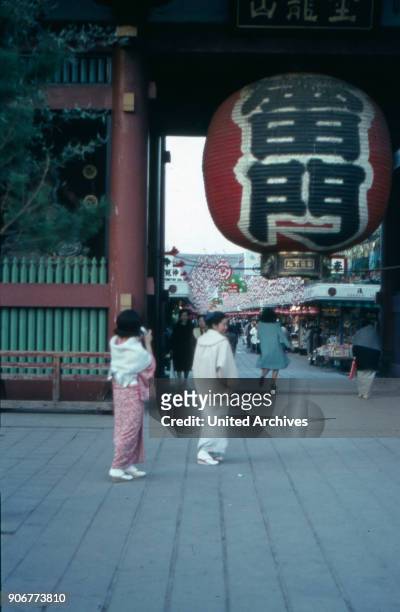 Two women at the entrance to the Asakusa temple at Tokyo, Japan 1960s.