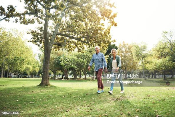 take a walk on the fun side of life - couple walking in park stock pictures, royalty-free photos & images