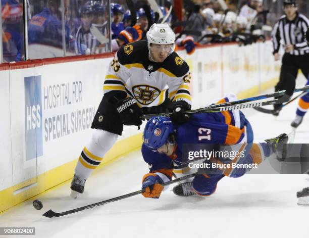 Brad Marchand of the Boston Bruins hits Mathew Barzal of the New York Islanders during the second period at the Barclays Center on January 18, 2018...