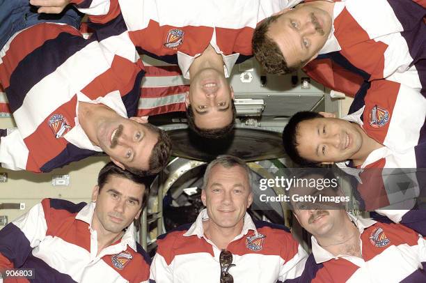 The crew of the Atlantis Space Shuttle on mission STS-106 pose for an inflight group portrait September 16, 2000 taken with an onboard preset...