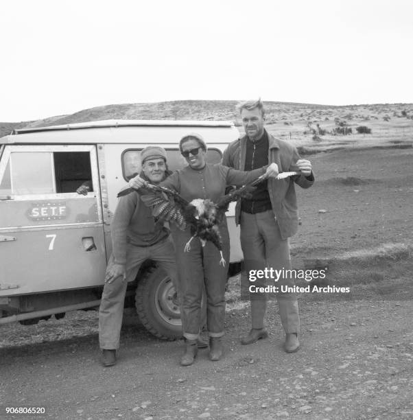 On the road near Cerro Castillo four young people caught a raptor, Chile 1960s.