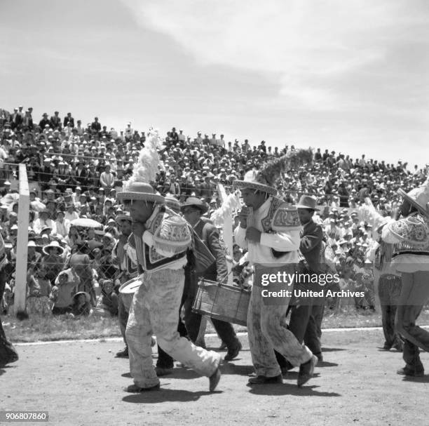 Carnival in Peru - disguised folks celebrating the Candelaria at Puno, Peru 1960s.