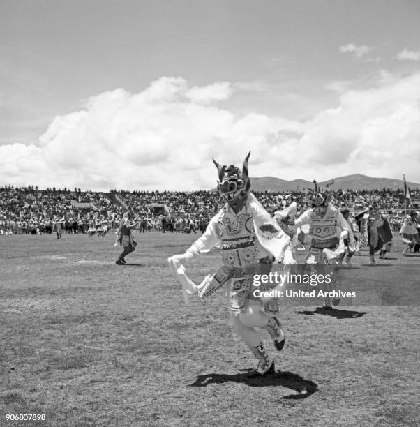 Carnival in Peru - disguised folks celebrating the Candelaria at Puno, Peru 1960s.