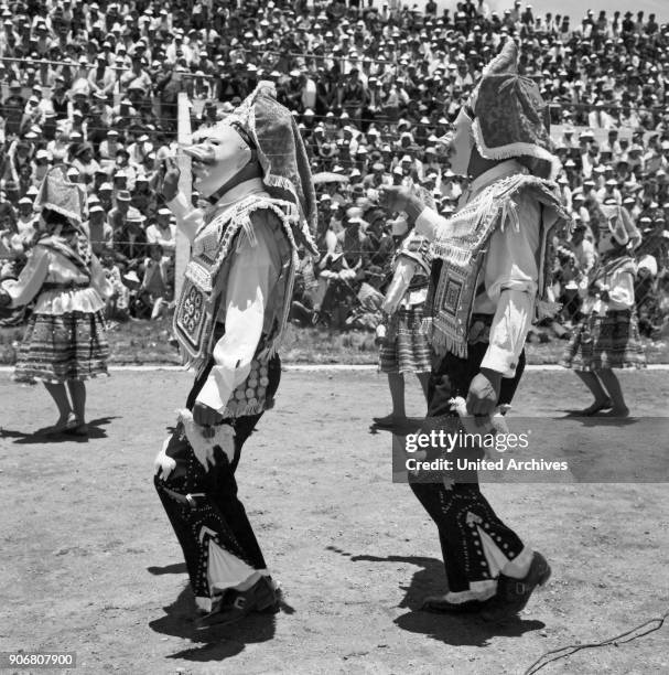 Carnival in Peru - disguised folks celebrating the Candelaria at Puno, Peru 1960s.