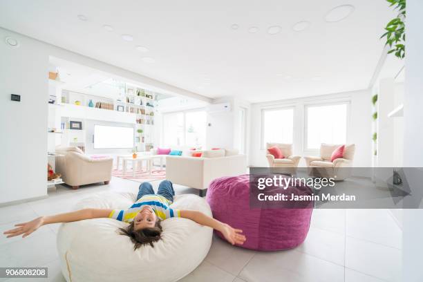 teenage kid enjoying inside new modern white home - one teenage boy only stock pictures, royalty-free photos & images