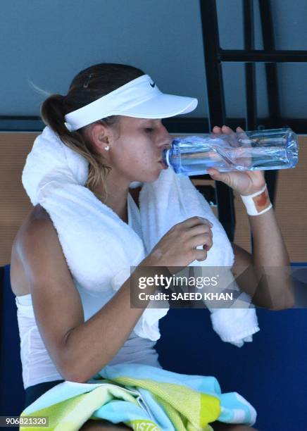 Czech Republic's Denisa Allertova uses an ice towel while drinking water during their women's singles third round match against Poland's Magda...