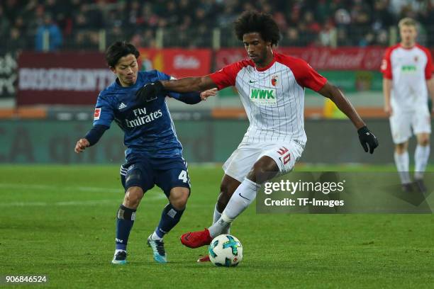 Tatsuya Ito of Hamburg and Francisco da Silva Caiuby of Augsburg battle for the ball during the Bundesliga match between FC Augsburg and Hamburger SV...