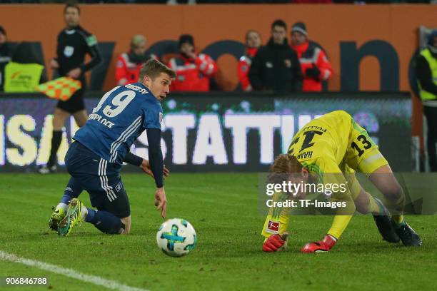 Sven Schipplock of Hamburg and Goalkeeper Julian Pollersbeck of Hamburg on the ground during the Bundesliga match between FC Augsburg and Hamburger...