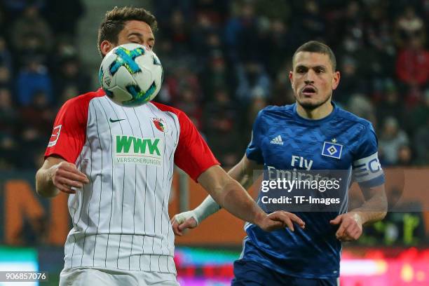 Rani Khedira of Augsburg and Kyriakos Papadopoulos of Hamburg battle for the ball during the Bundesliga match between FC Augsburg and Hamburger SV at...