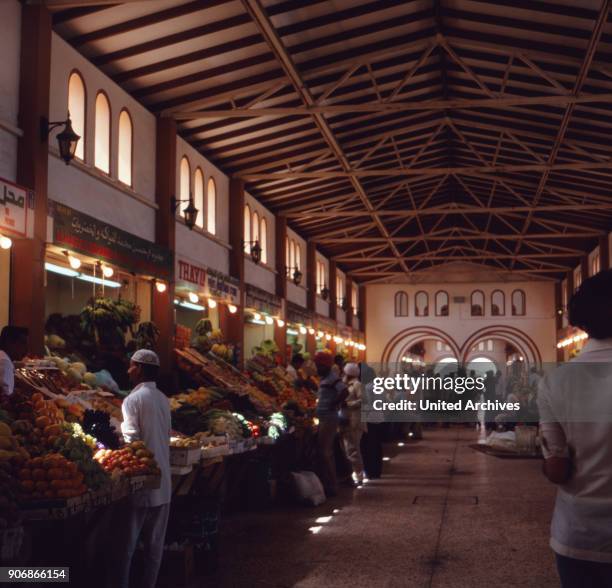 Shopping in the market halls of Sharjah, United Arab Emirates 1970s.