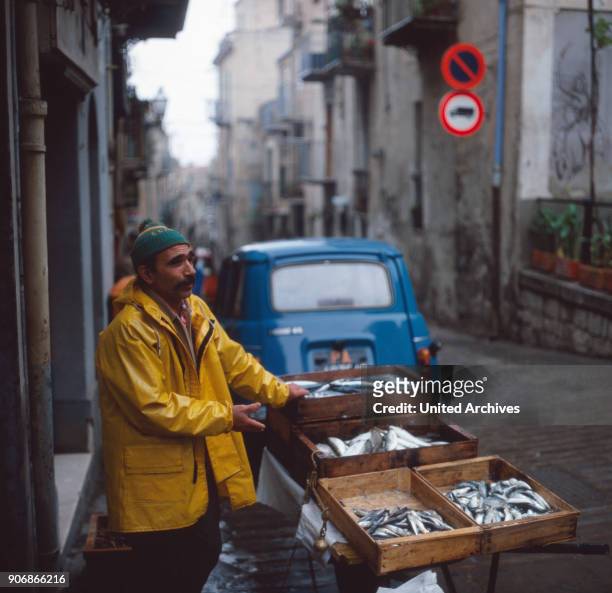 Fish seller in the streets of Cefale, Sicily, Italy 1970s.
