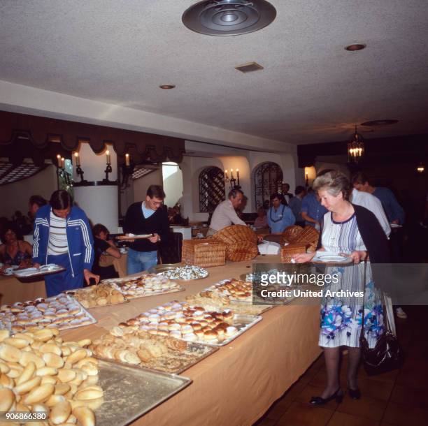 Hungry tourists at the cake buffet of Hotel Buenaventura, Playa del Ingles, Grand Canary 1980s.