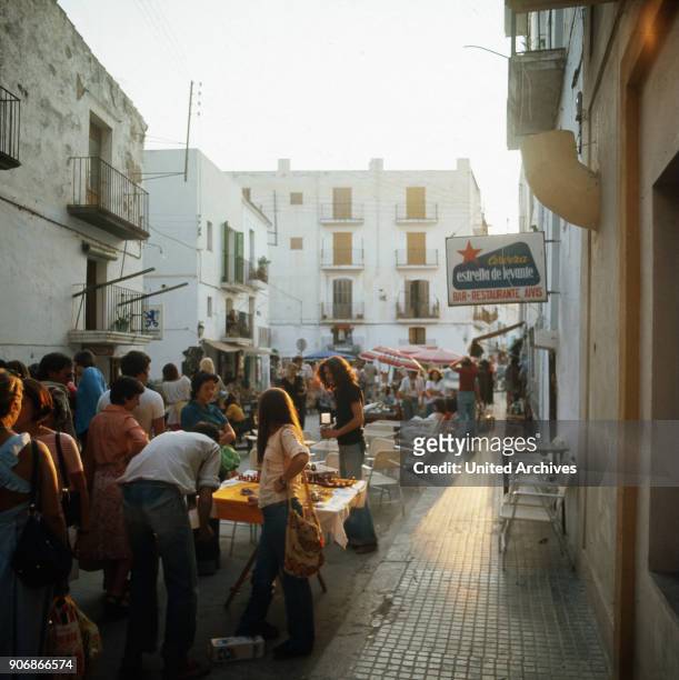 Shopping at a hippie market in the city of Ibiza, Ibiza 1976.