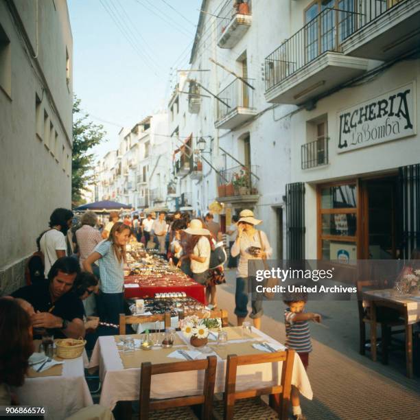 Shopping at a hippie market in the city of Ibiza, Ibiza 1976.