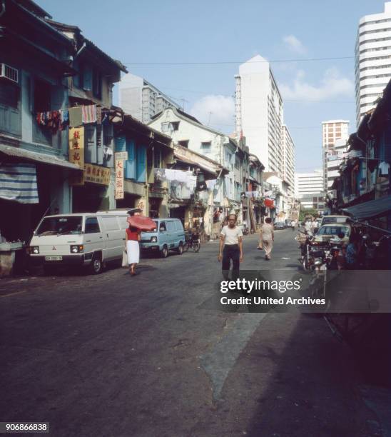 On the way in the streets of Chinatown in Singapore, 1980s.
