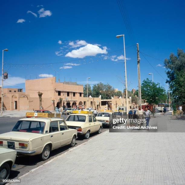 Taxis in a street of Ouarzazate in the South of Morocco, 1980s.