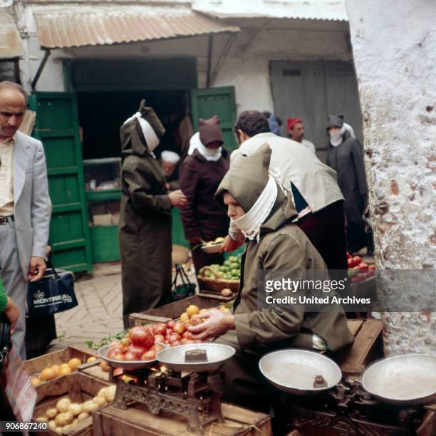 People on the market at Marrakech, Morocco 1980s.