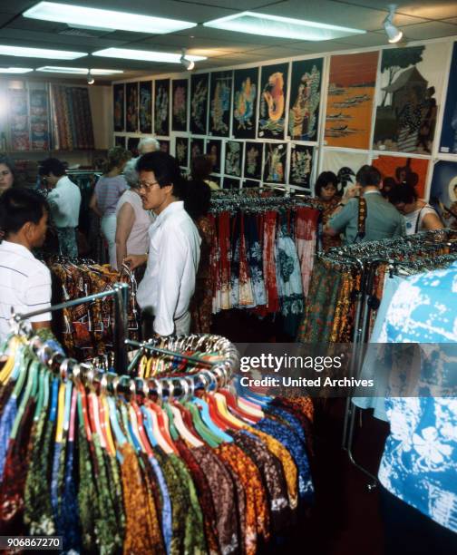 Vendor and customers at a batik shop, Singapore 1980s.