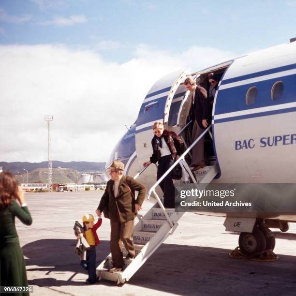 Passengers leaving a plane of the Bavaria Germanair airline at Munich airport, Germany 1970s.