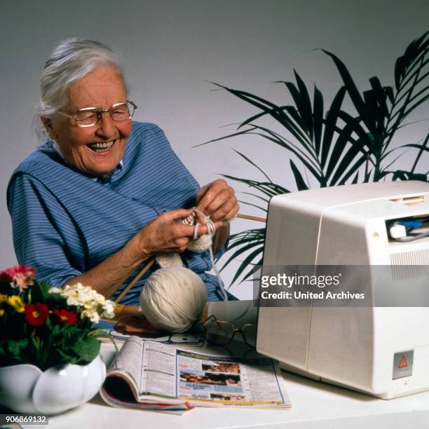 Senior woman knitting, 1980s.