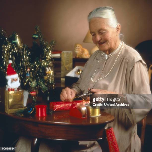 Senior woman with Christmas gifts, 1980s.