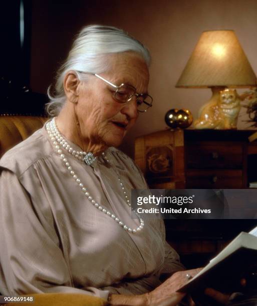 Senior woman reading, 1980s.