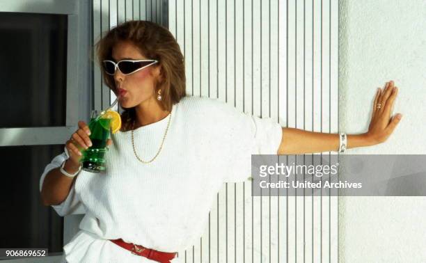 Woman with cocktail, 1980s.