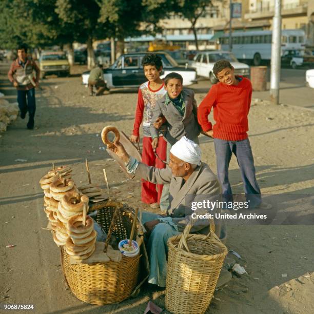 Bread vendor in the streets of Cairo, Egypt, late 1970s.