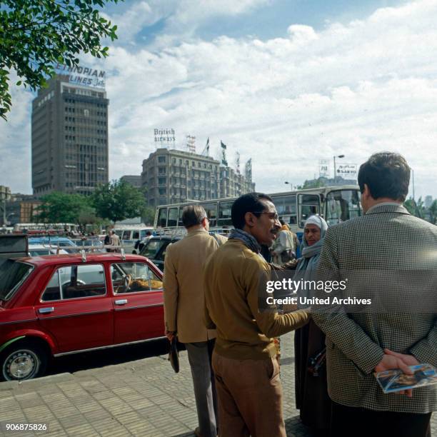 Cairenes discussing on the streets near Midan al Tahrir square at Cairo, Egypt, late 1970s.