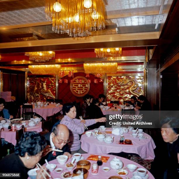 People having lunch at a restaurant in Hong Kong, early 1980s.